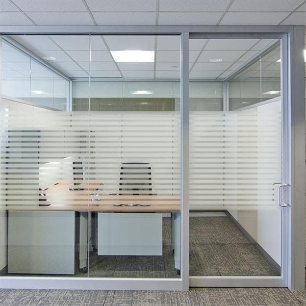 Kontorlokale med glasvæg, sandblæst stribemønster, lysgennemtrængende for privatliv.
